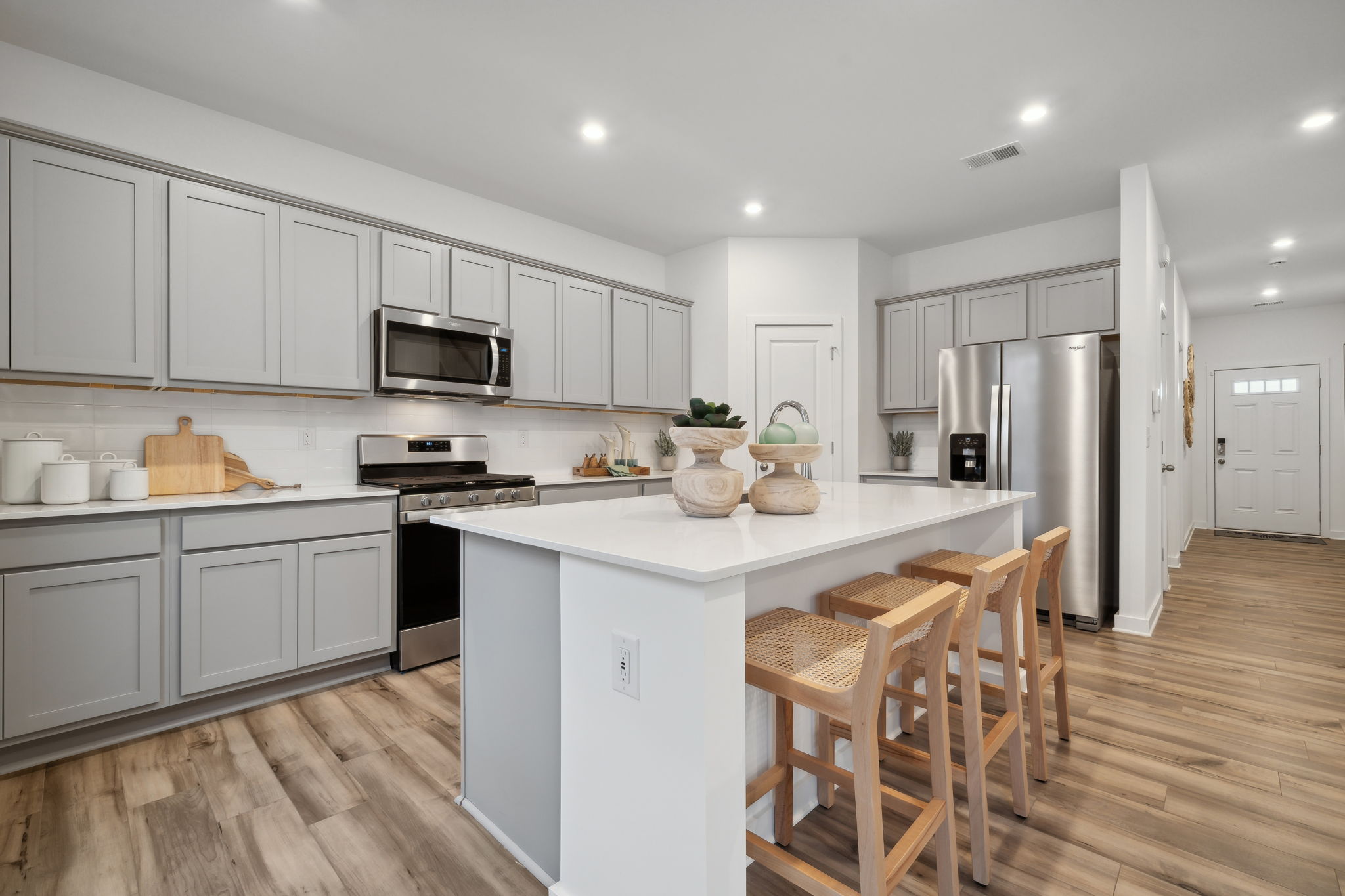 A kitchen with white cabinets.