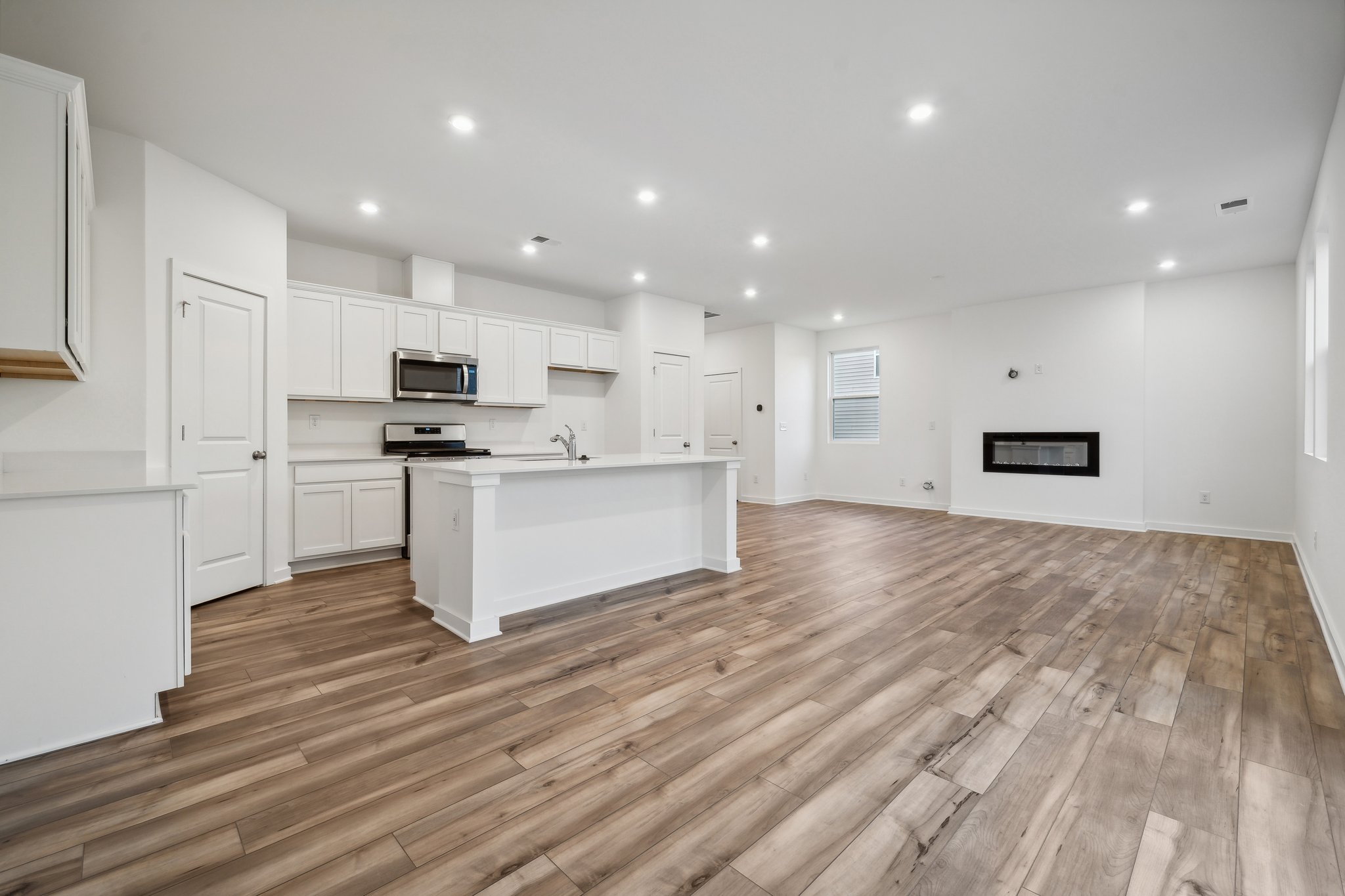 A kitchen with white cabinets.