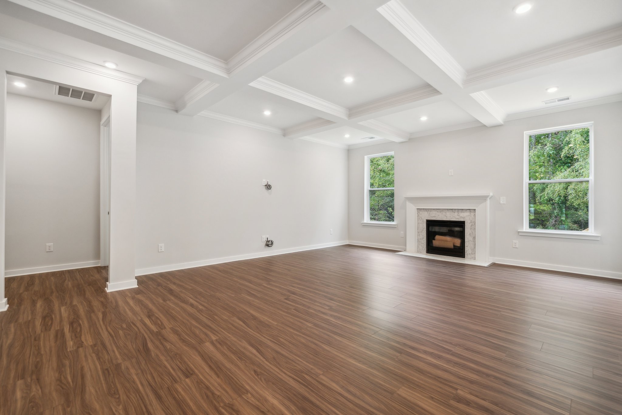 A large empty room with a fireplace.