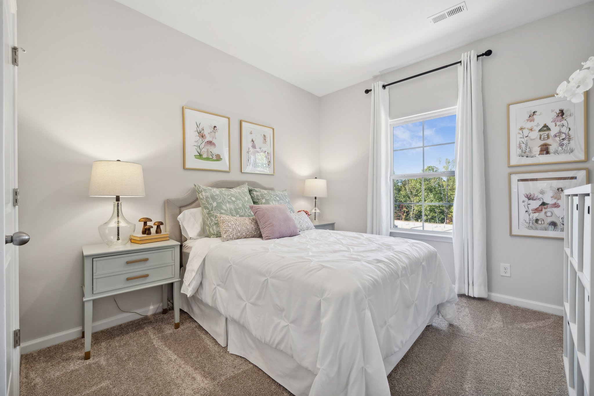 A bedroom with a bed and a window.