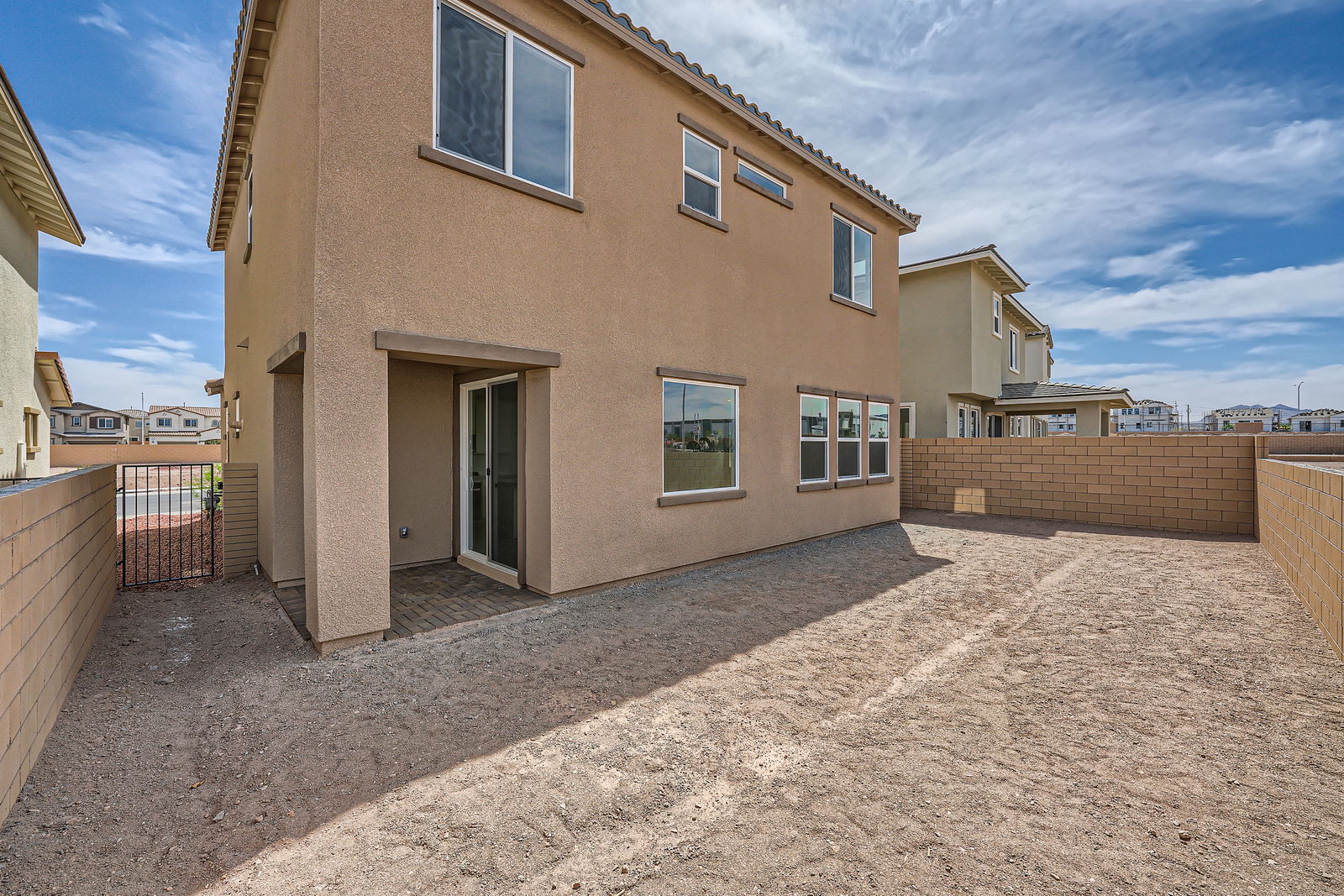 A building with a dirt yard.