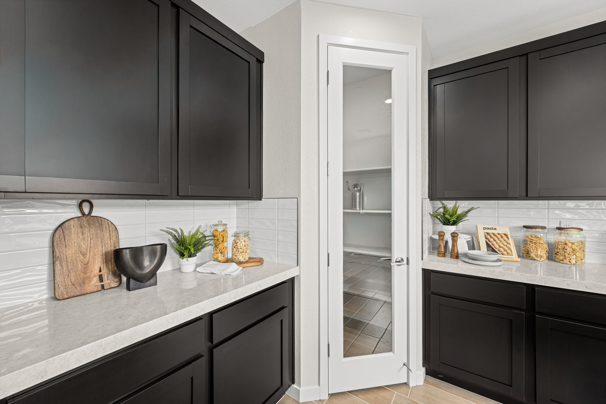 A kitchen with black cabinets.