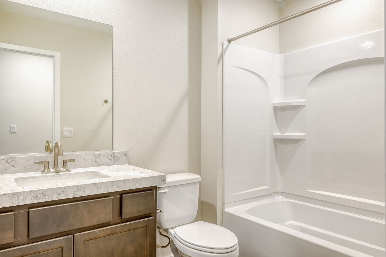 A bathroom with a tub sink and toilet.