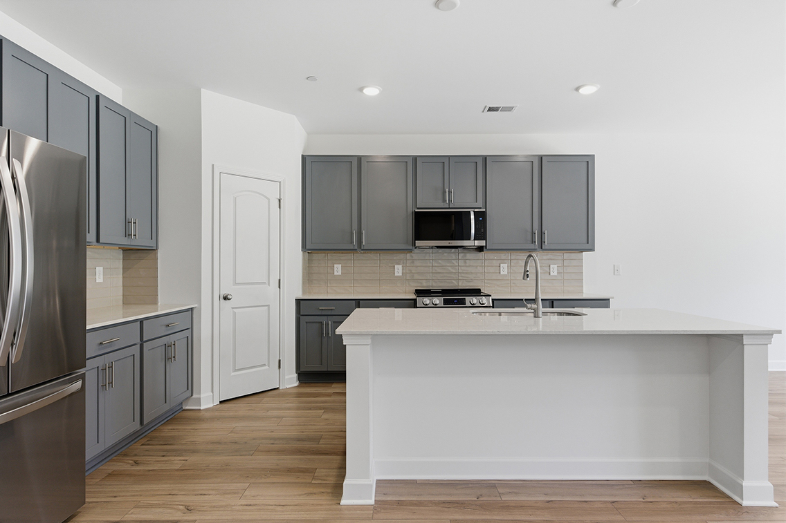 A kitchen with black cabinets.