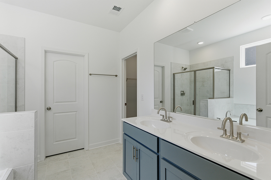 A bathroom with a large mirror.