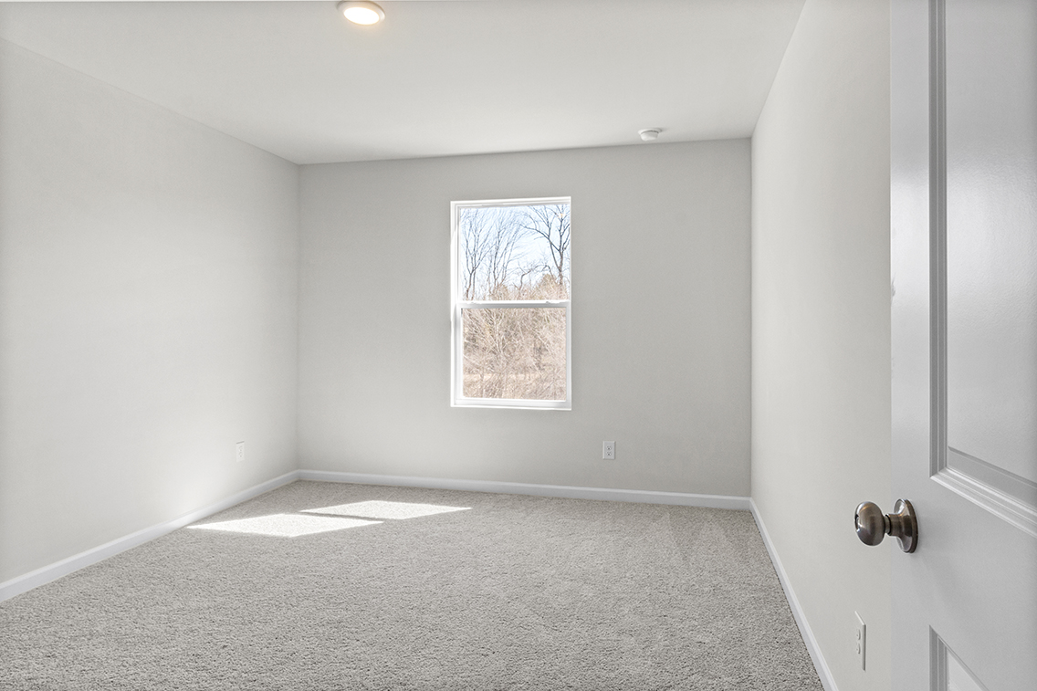 A room with a window and a door.