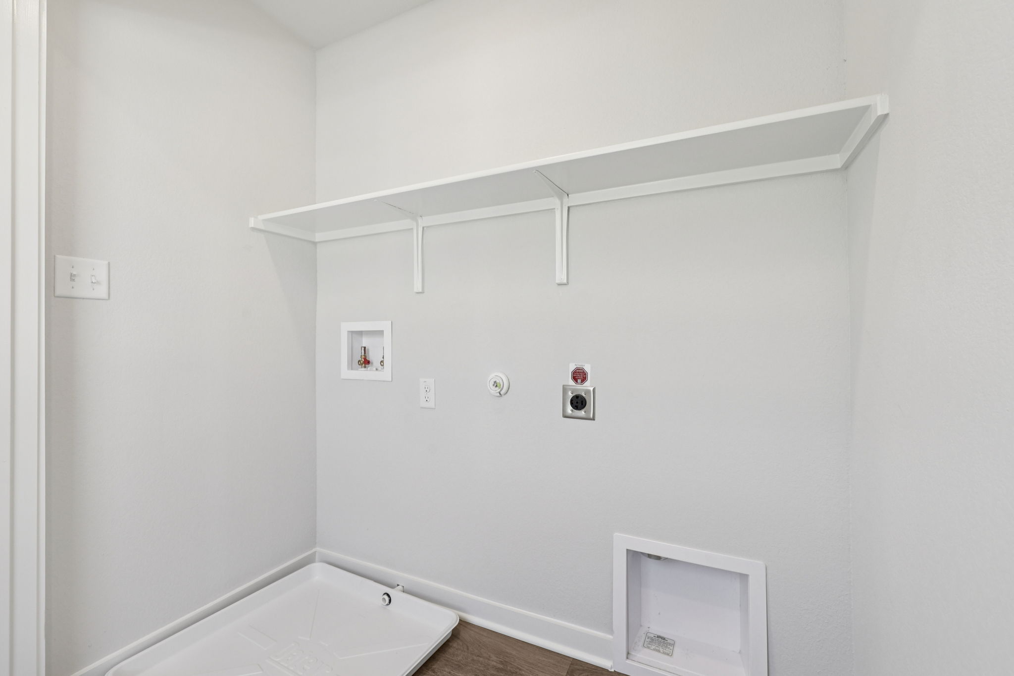 A white wall with a white door.