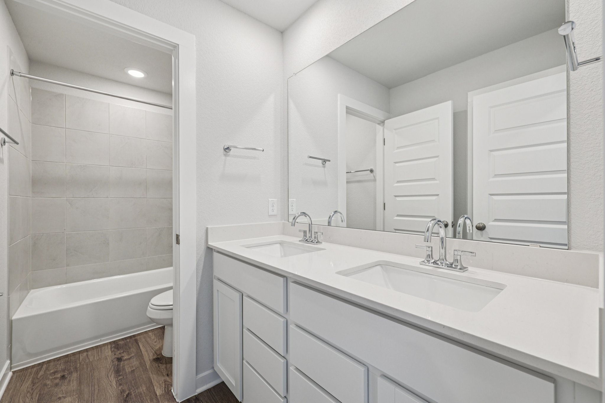 A bathroom with a tub sink and toilet.