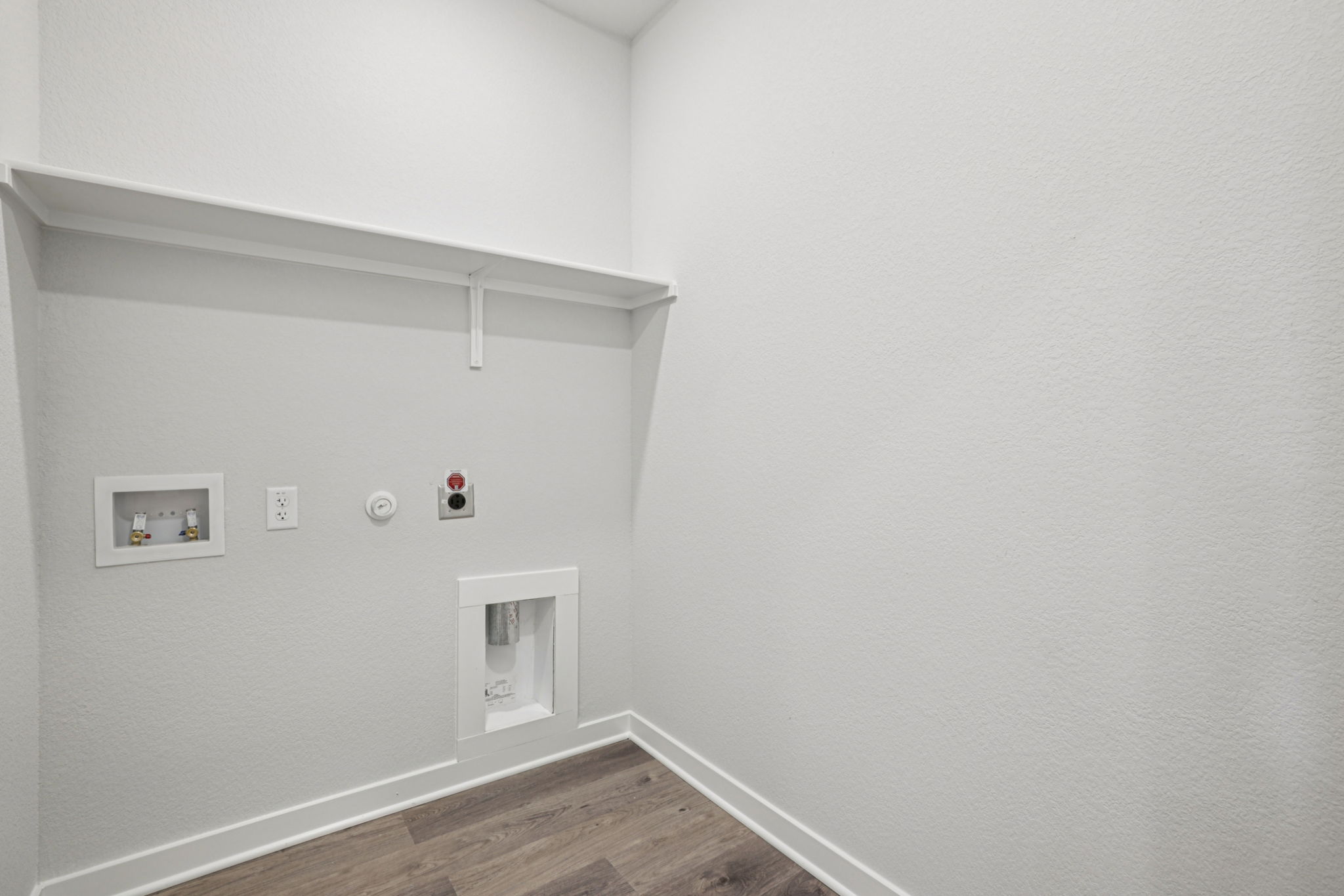 A white wall with pictures on it.