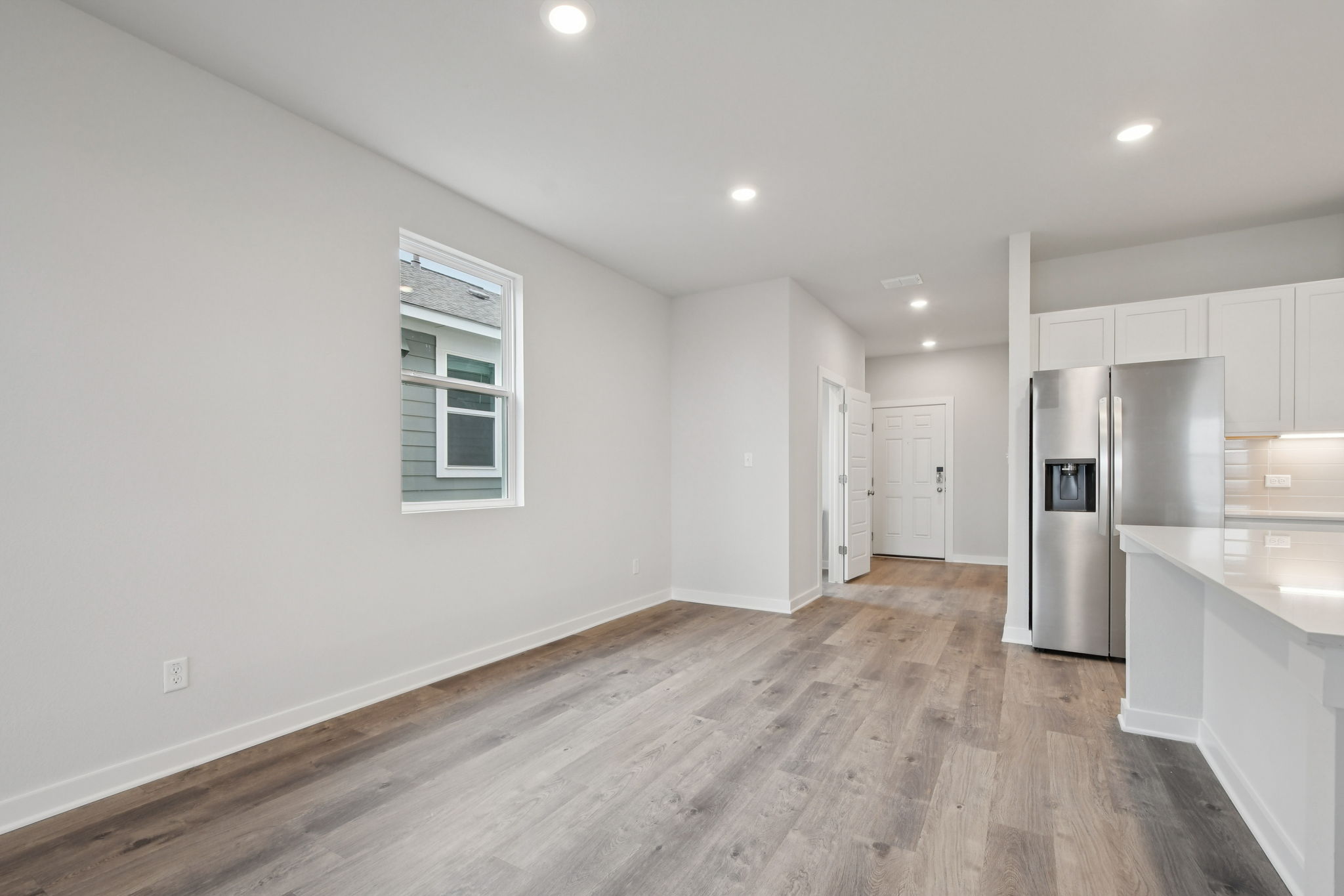 A kitchen with white cabinets.