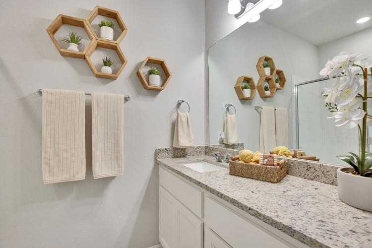 A bathroom with a marble countertop.
