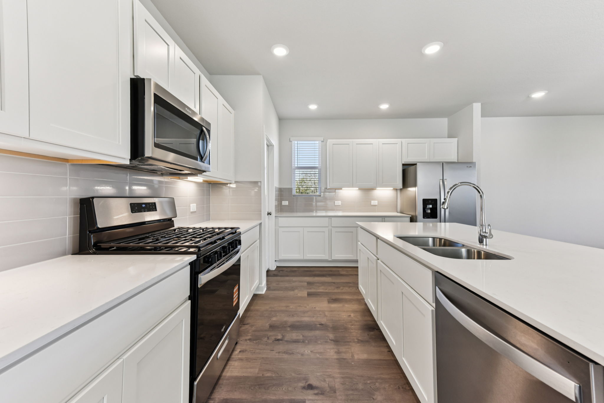 A kitchen with white cabinets.