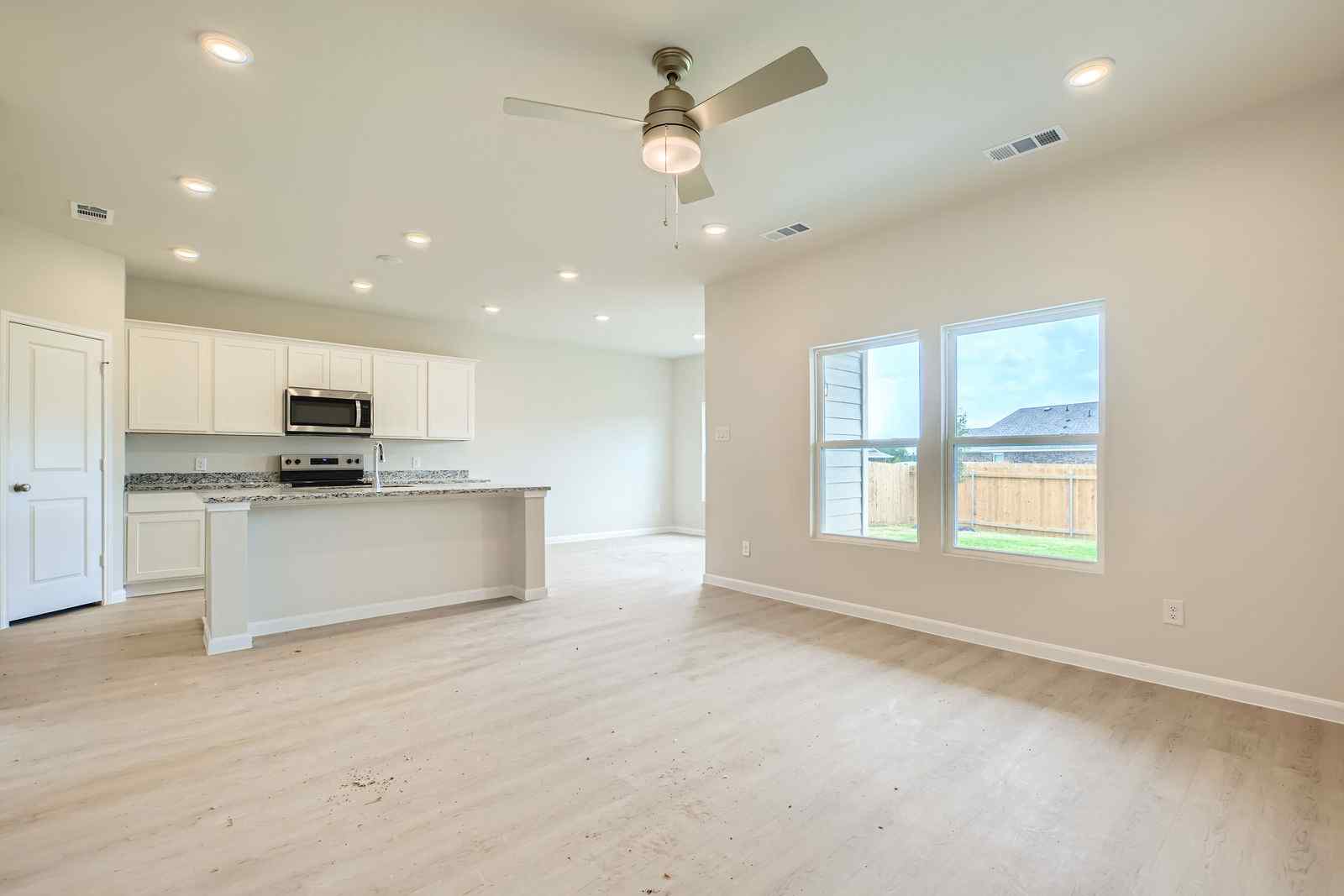 A kitchen with a large window.