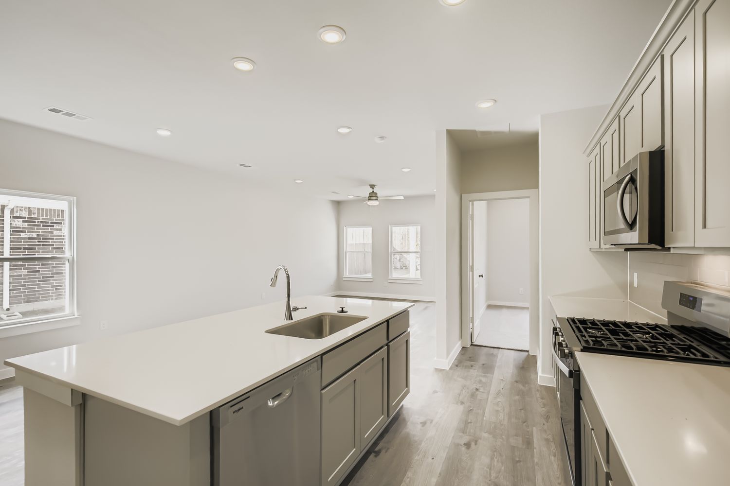 A kitchen with white cabinets.
