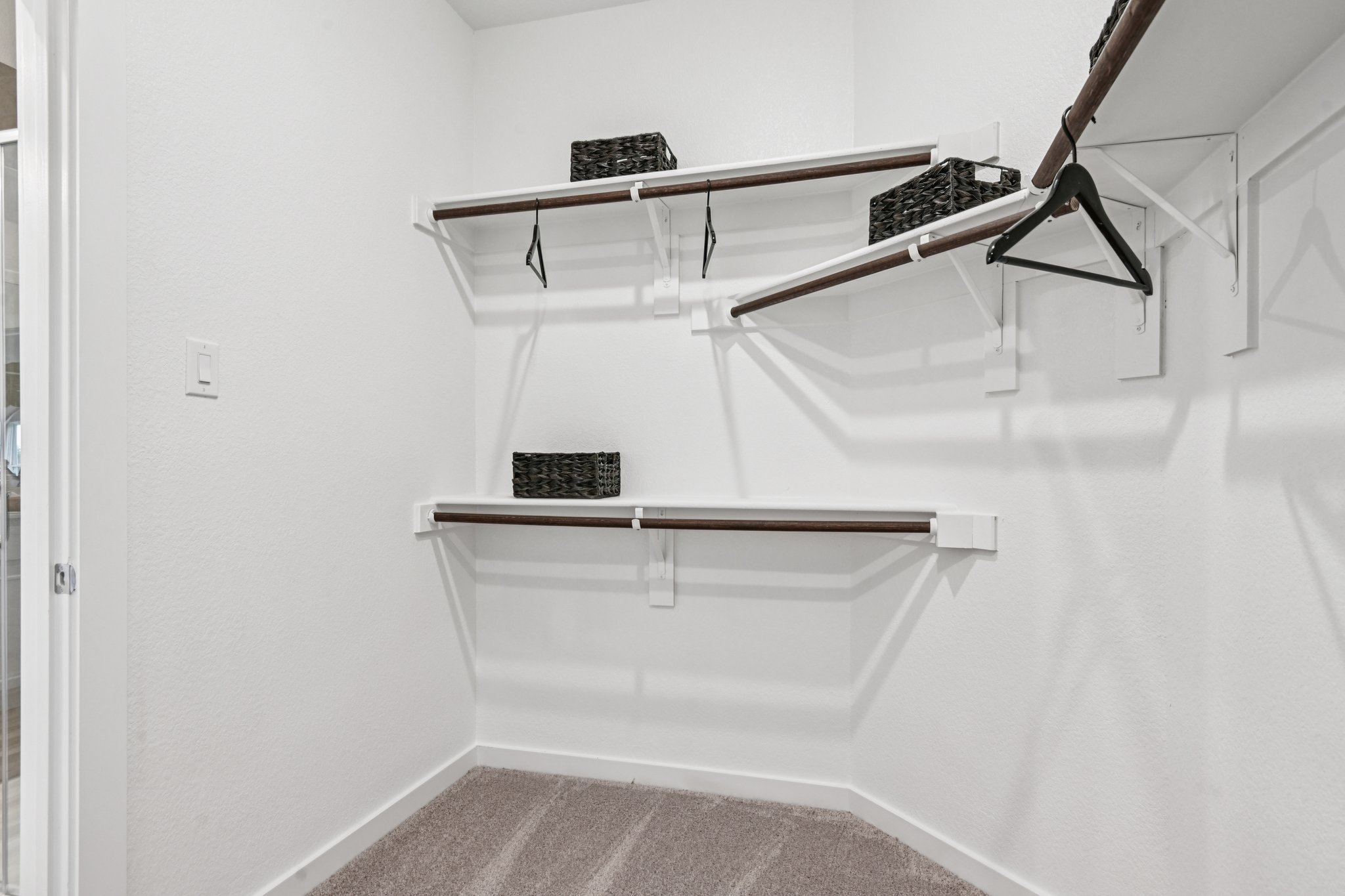 A white staircase with a black basket.