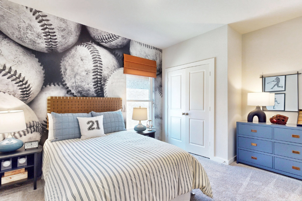 A bedroom with a bed and a dresser.