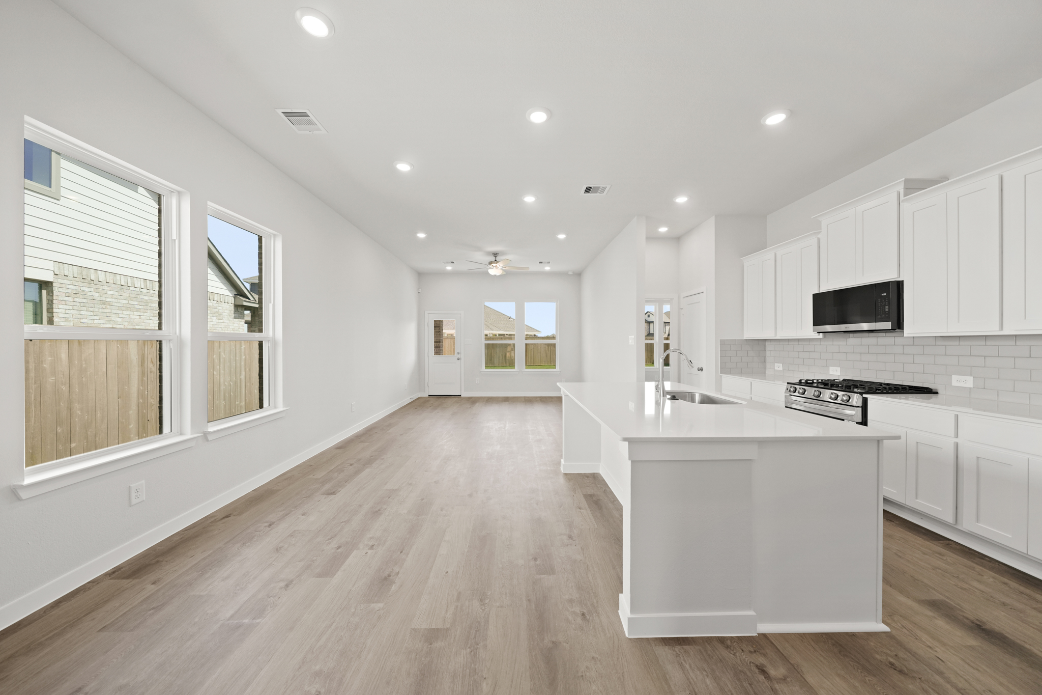 A kitchen with white cabinets.
