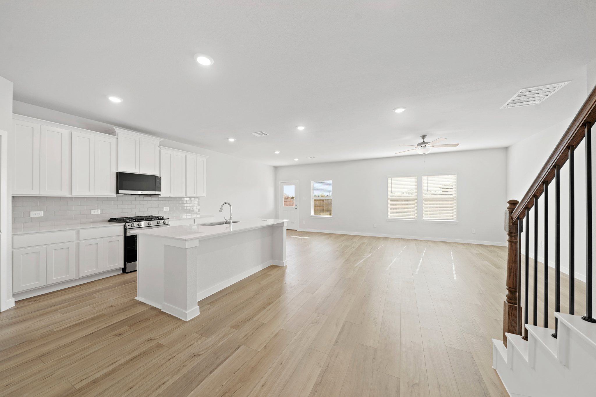 A kitchen with white cabinets.