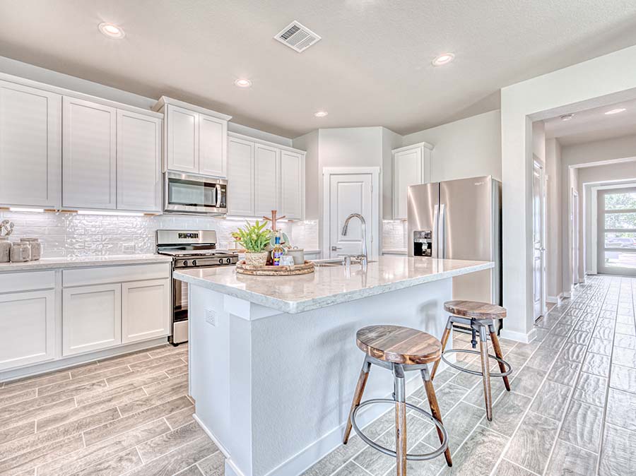 A kitchen with white cabinets.