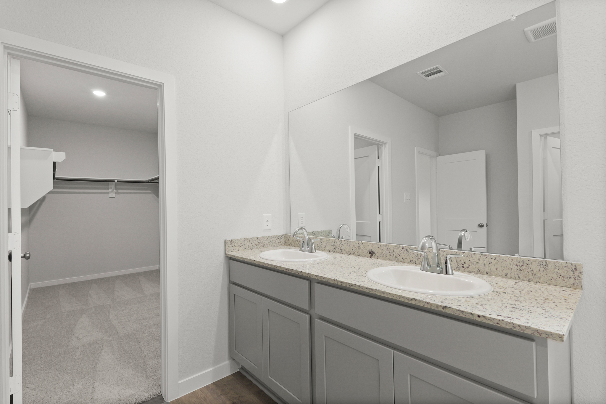 A bathroom with a large mirror.