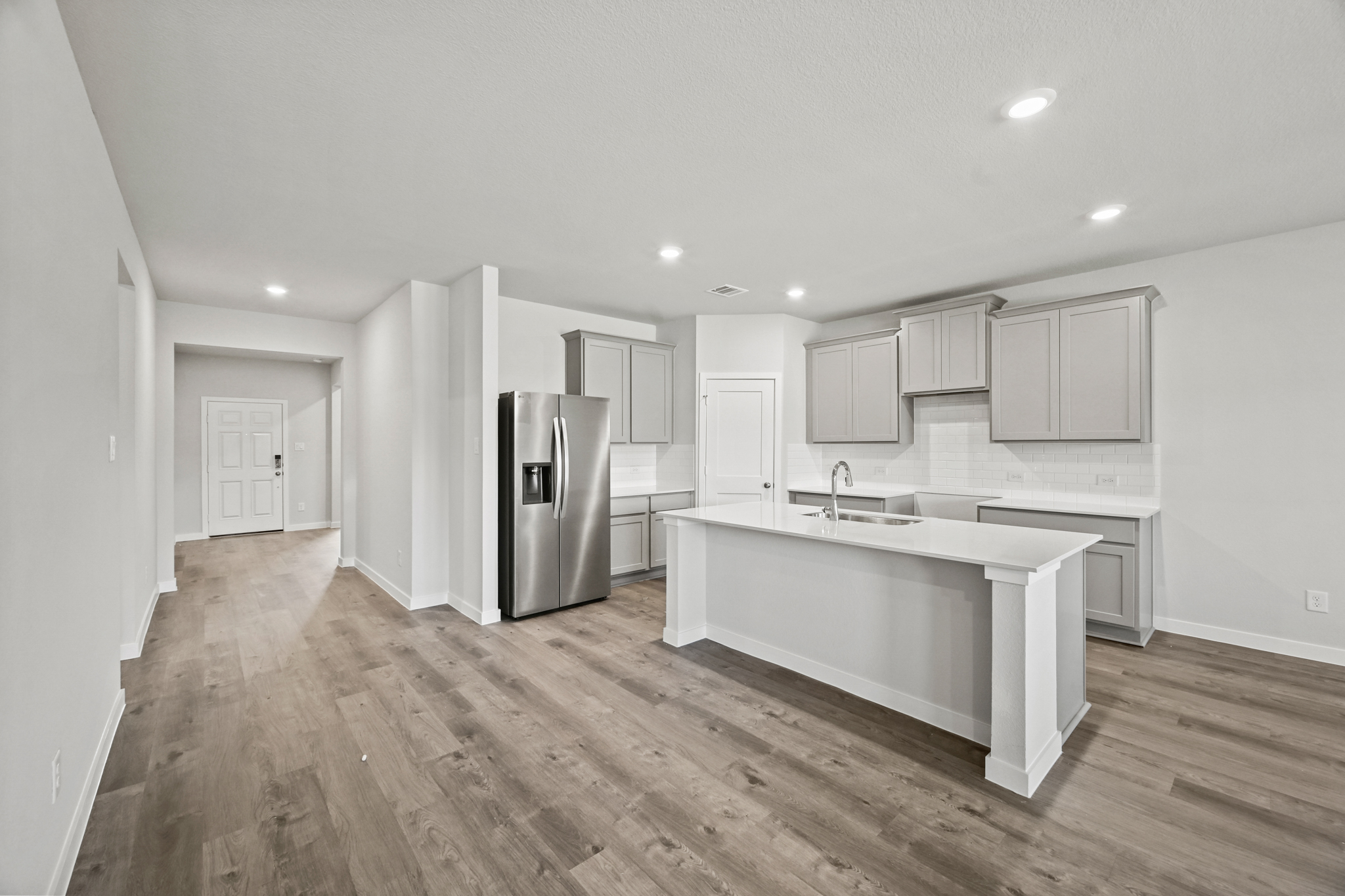 A kitchen with white cabinets.