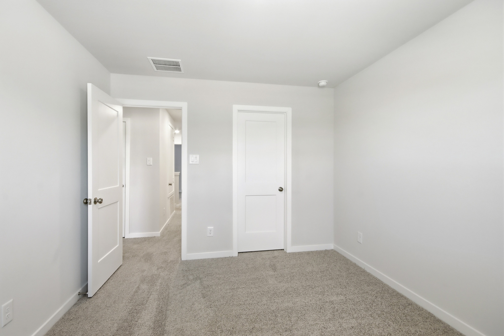 A hallway with white doors.