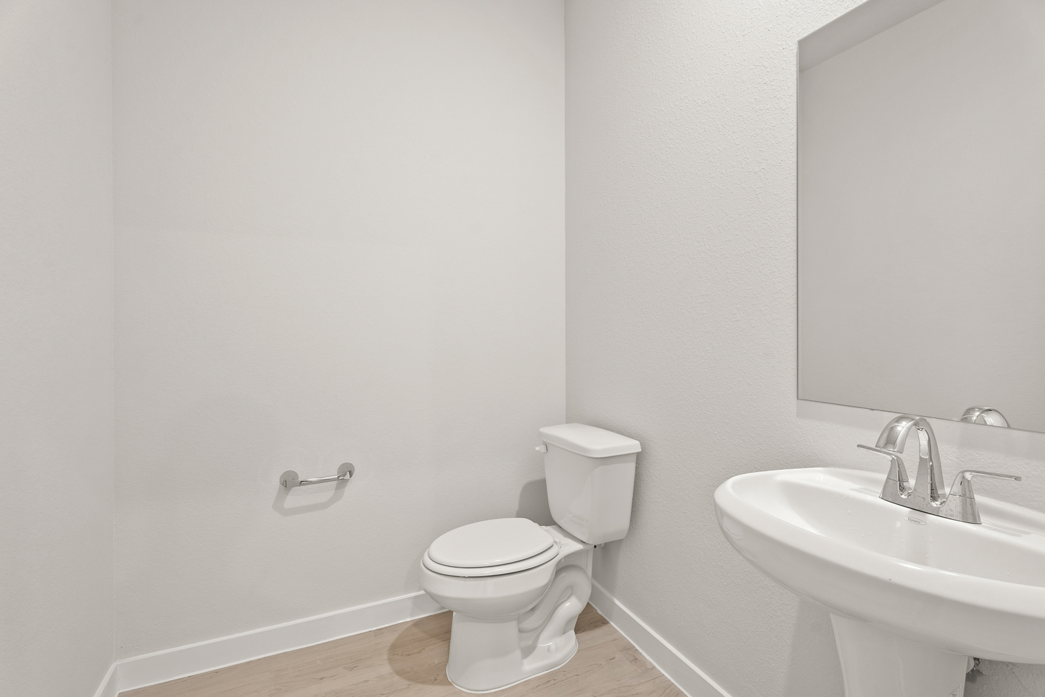 A bathroom with a toilet and sink.