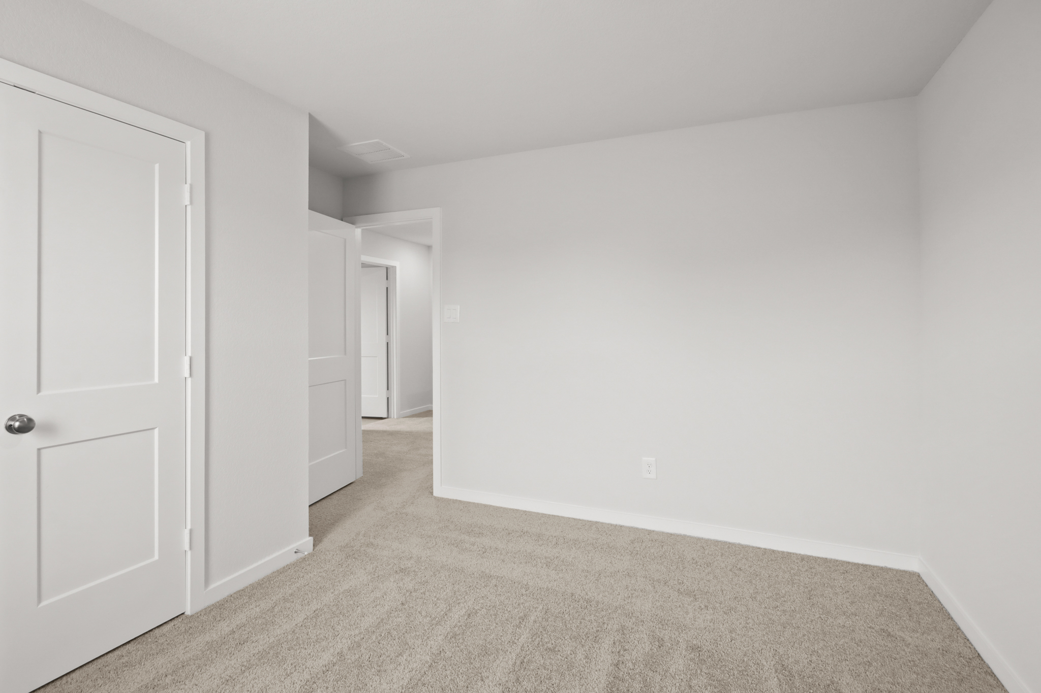 A hallway with white doors.