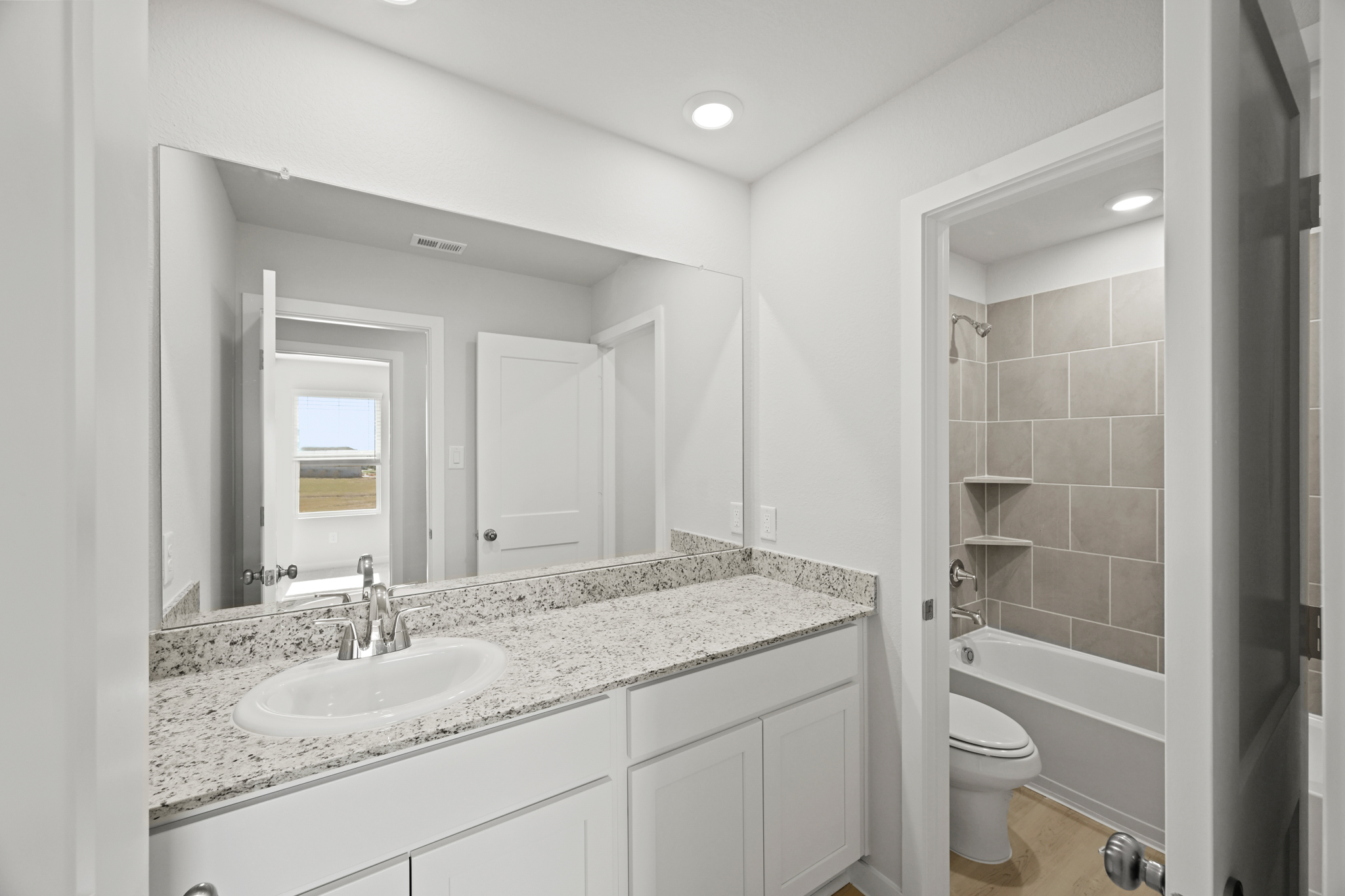 A bathroom with a marble countertop.