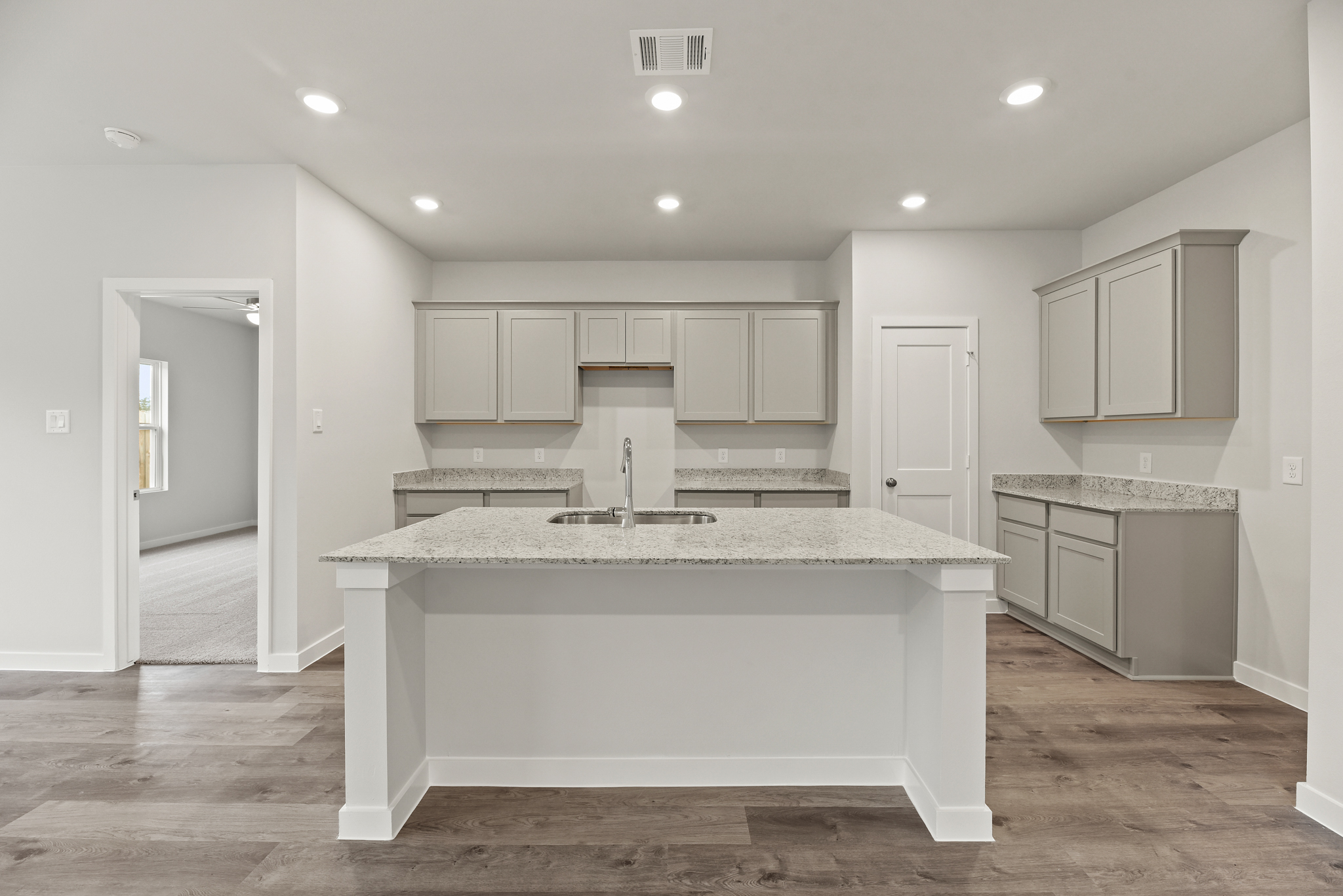 A kitchen with white cabinets.