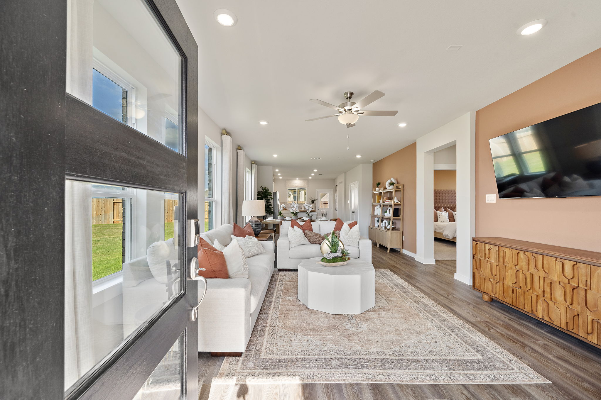 A large living room with a glass wall.