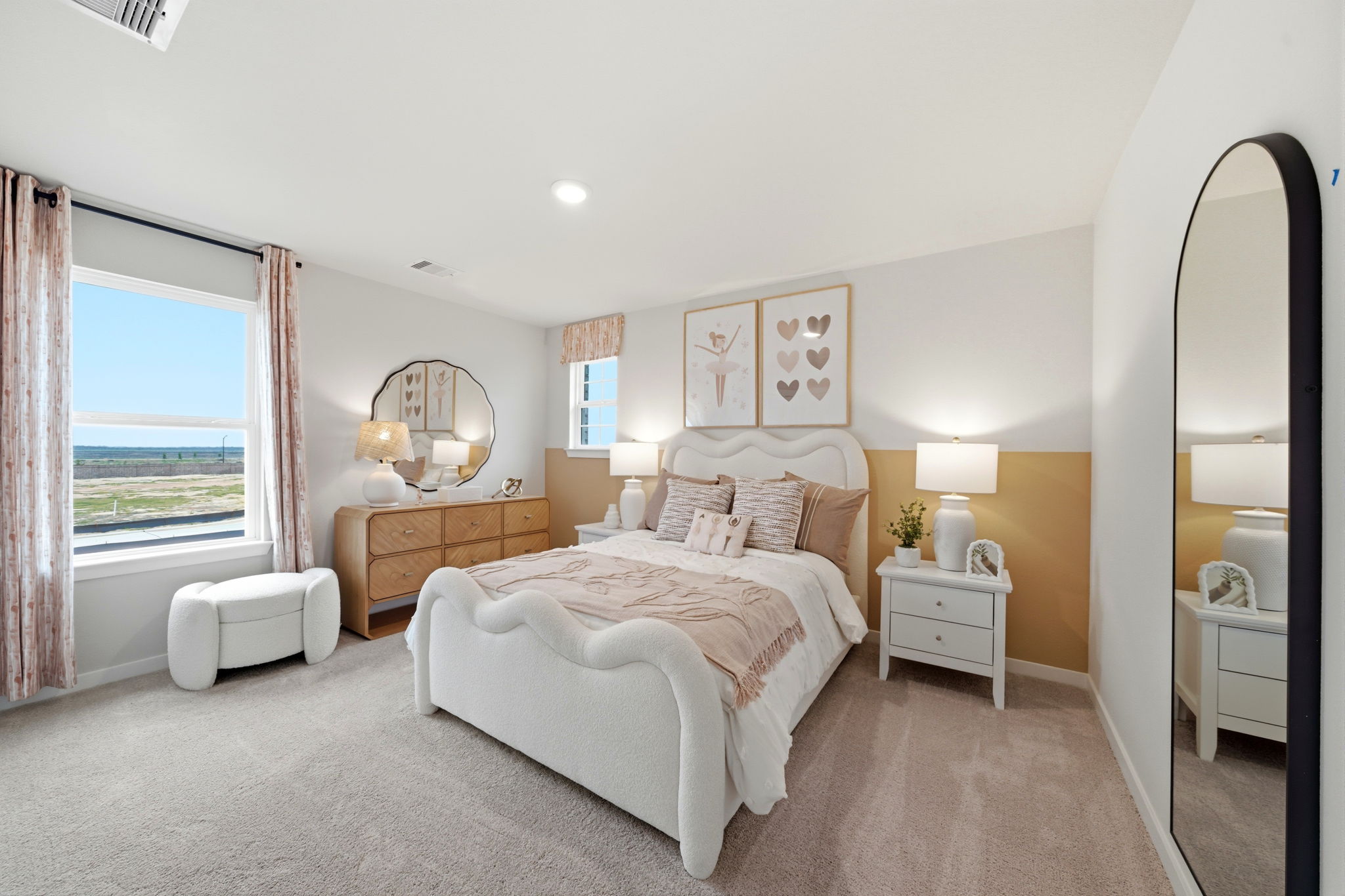 A bedroom with a large mirror.