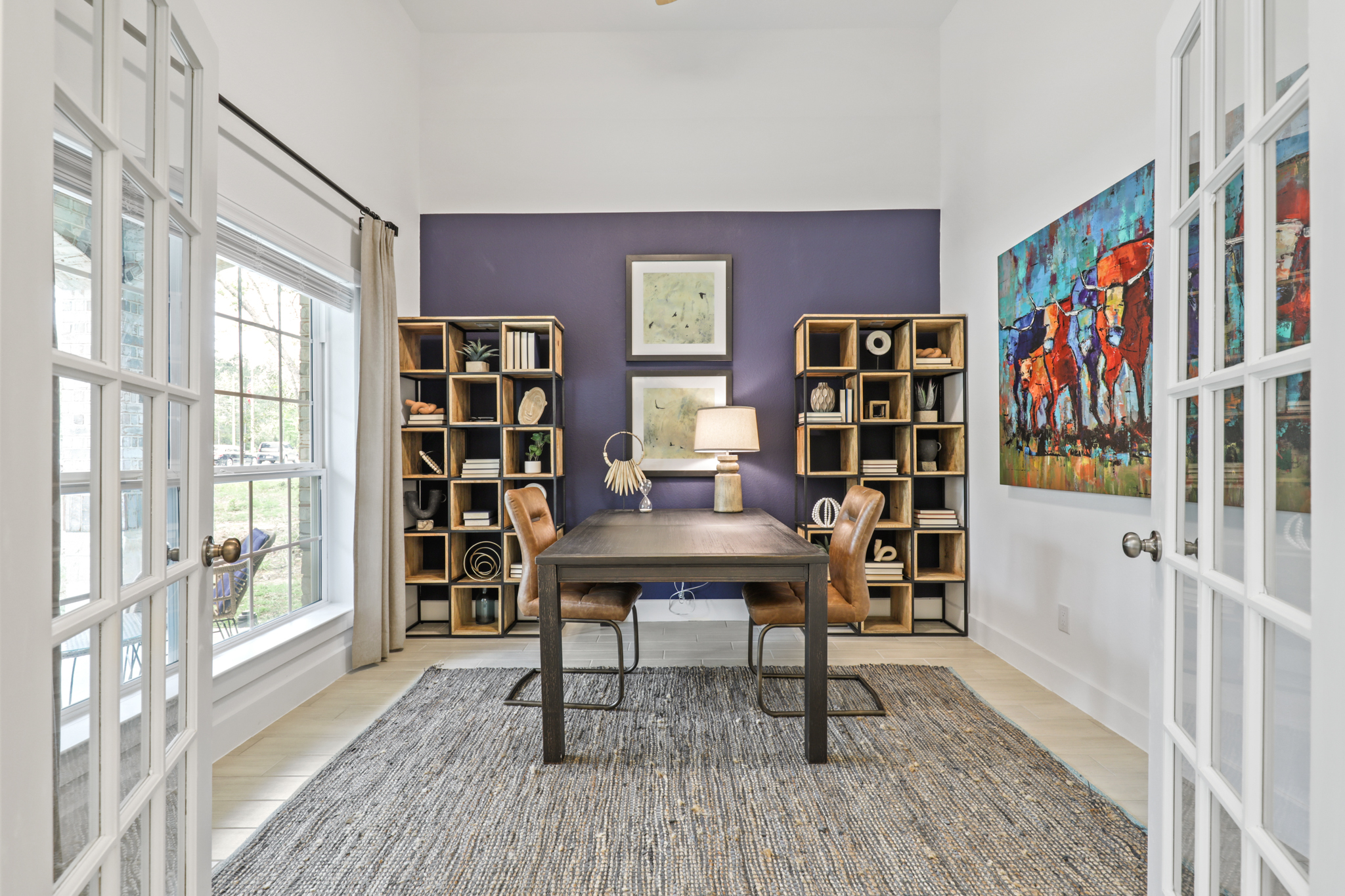 A room with a table and bookshelves.