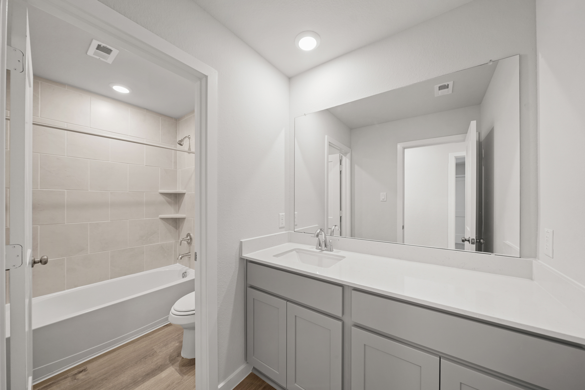 A bathroom with a tub sink and toilet.