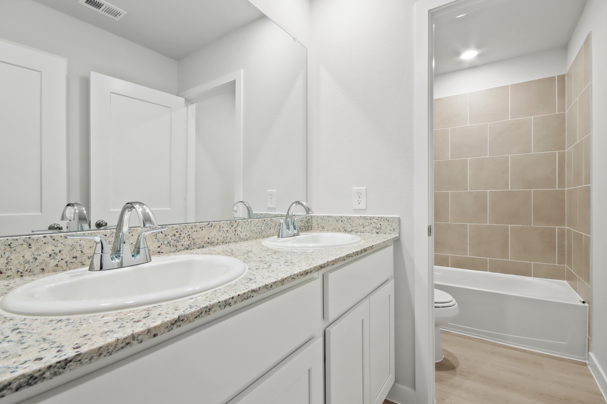 A bathroom with a tub sink and a toilet.