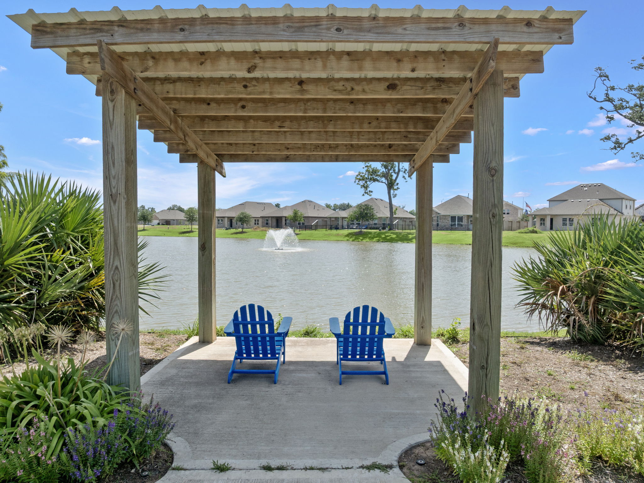 A gazebo with chairs and a body of water in the background.