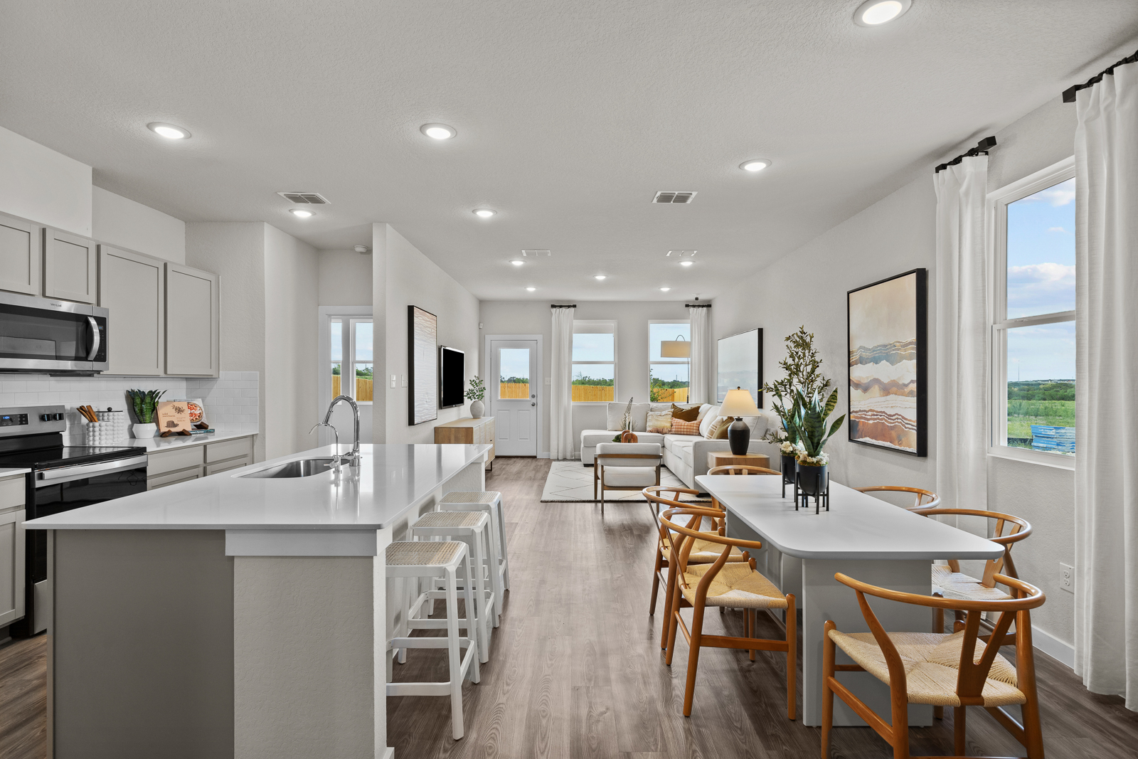 A kitchen with a dining table and chairs.