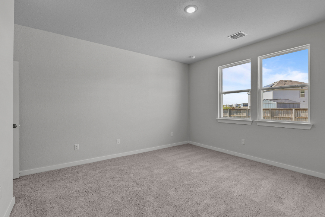 A room with a window and a carpet.