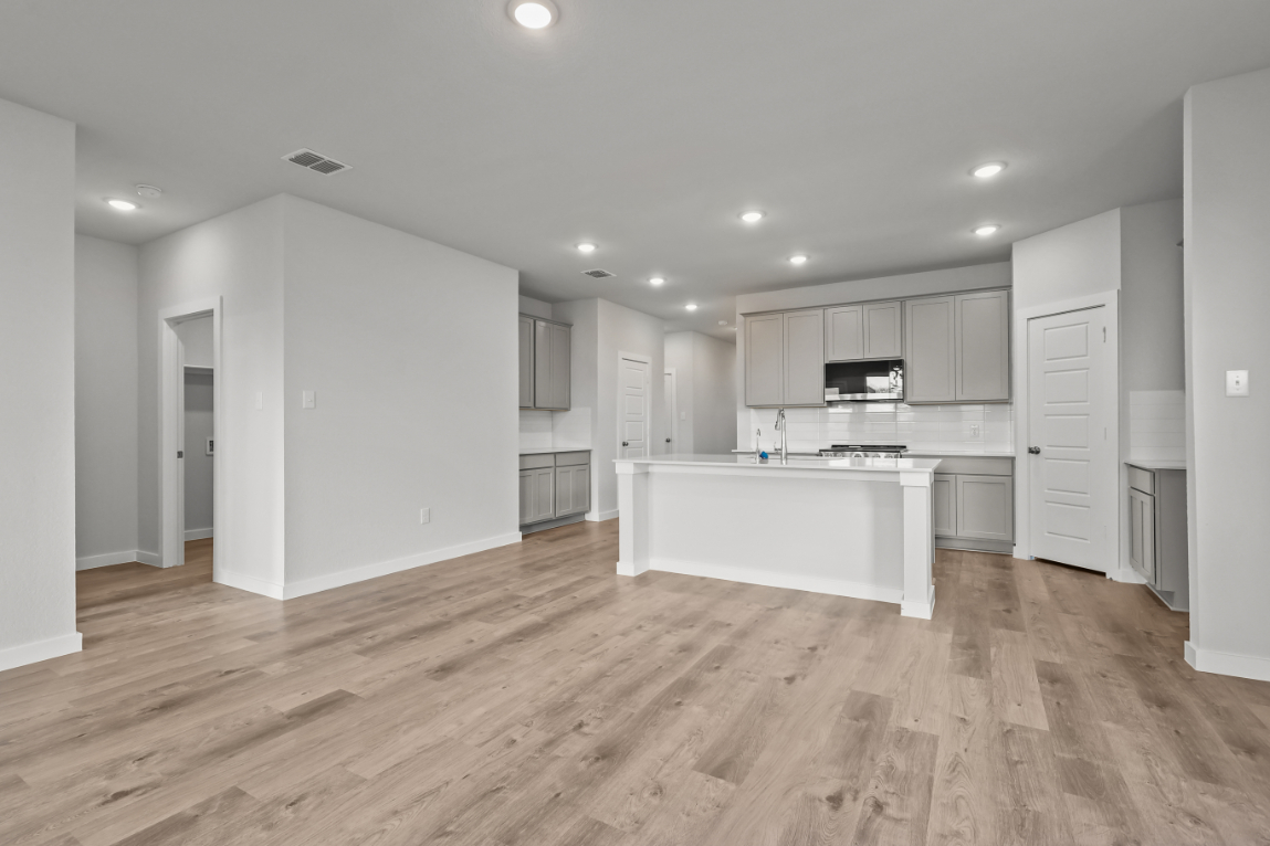 A large kitchen with white cabinets.