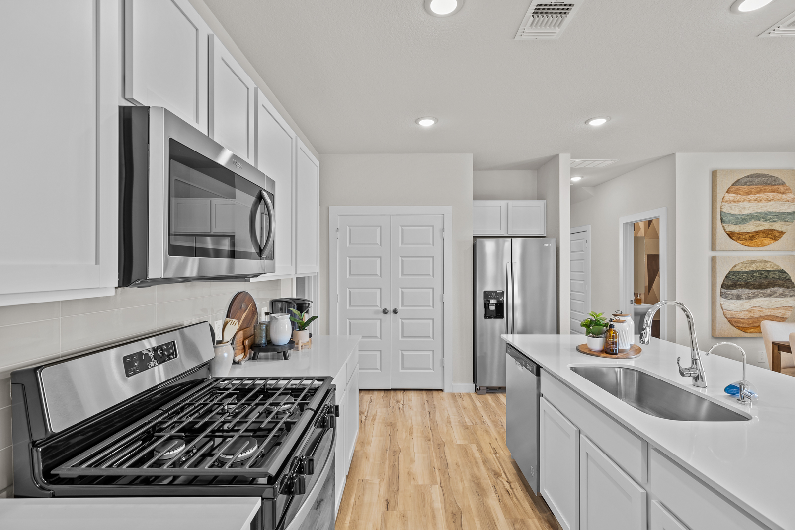 A kitchen with white cabinets.