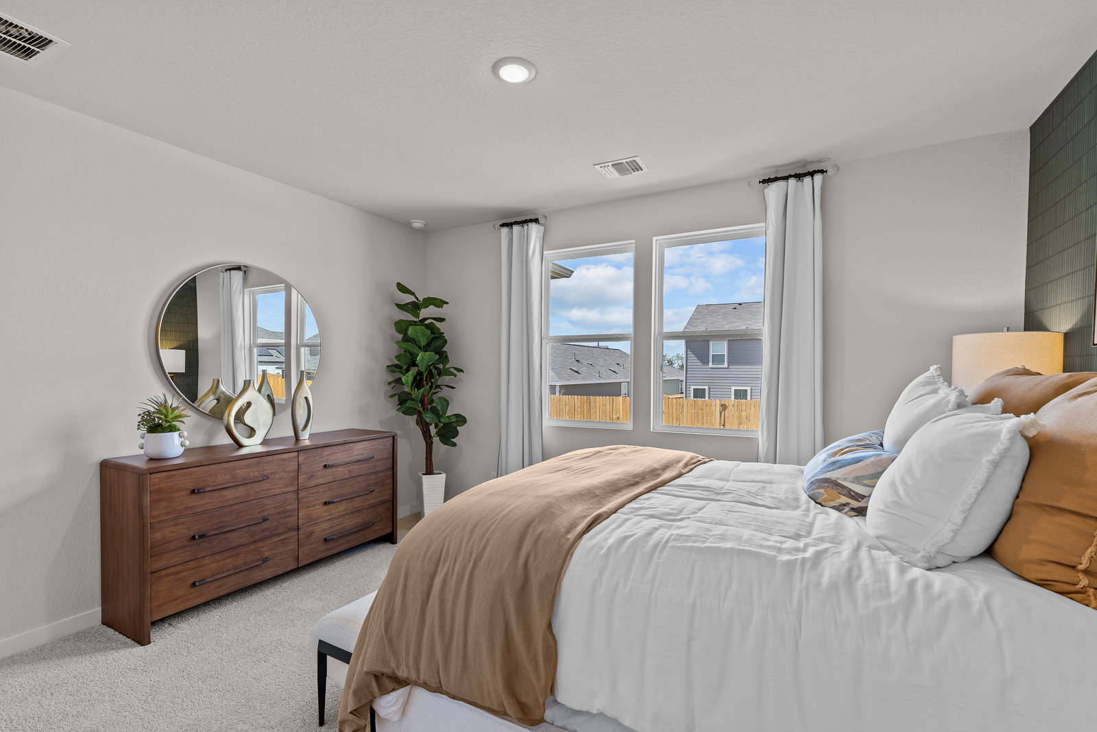 A bedroom with a large window.