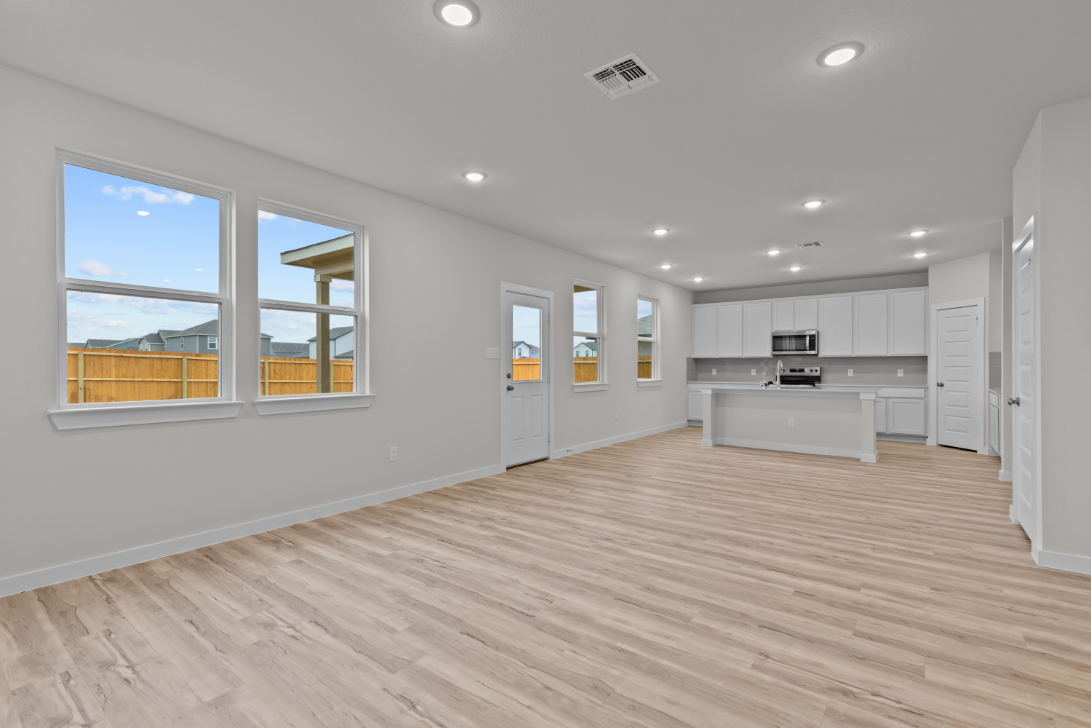 A kitchen with white cabinets.