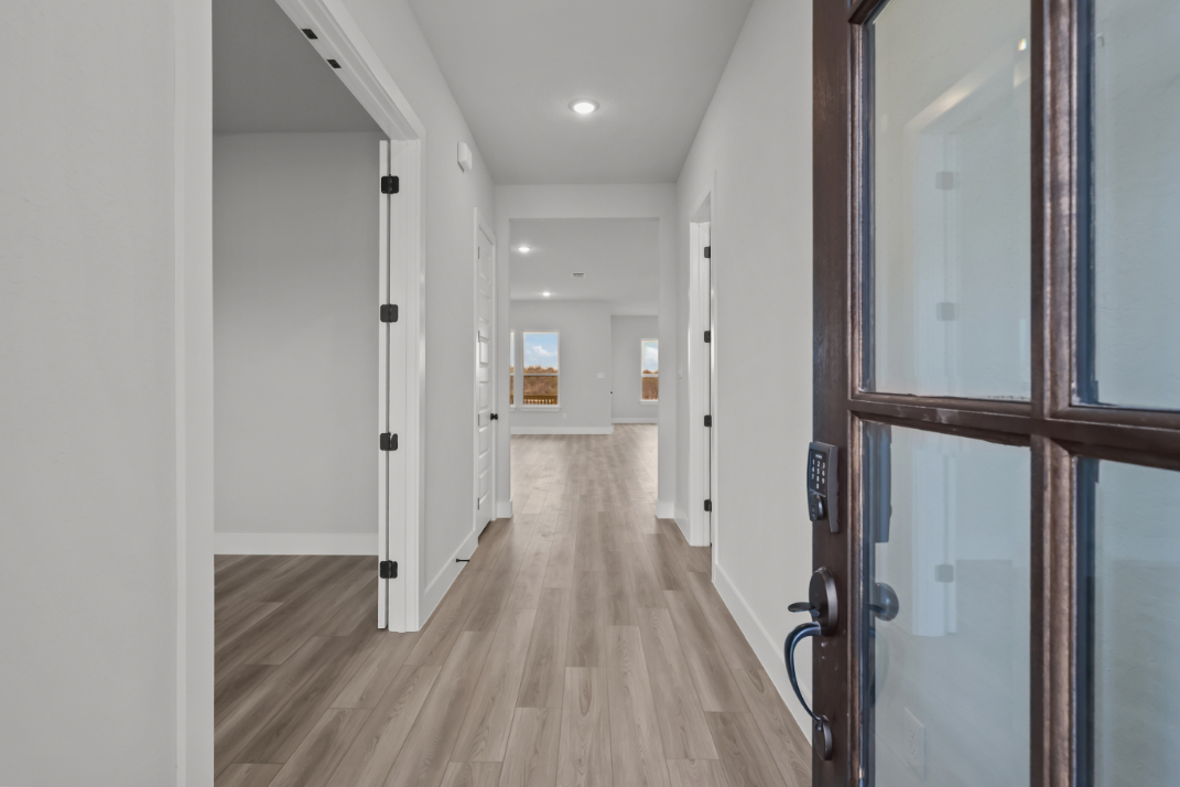 A hallway with white doors.