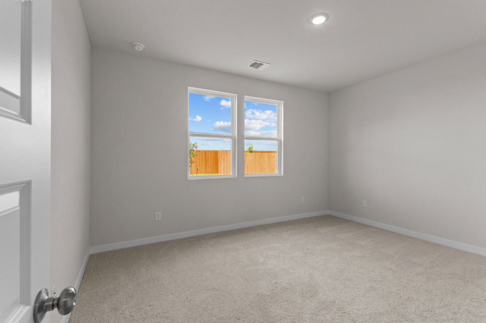 A room with a window and carpet.