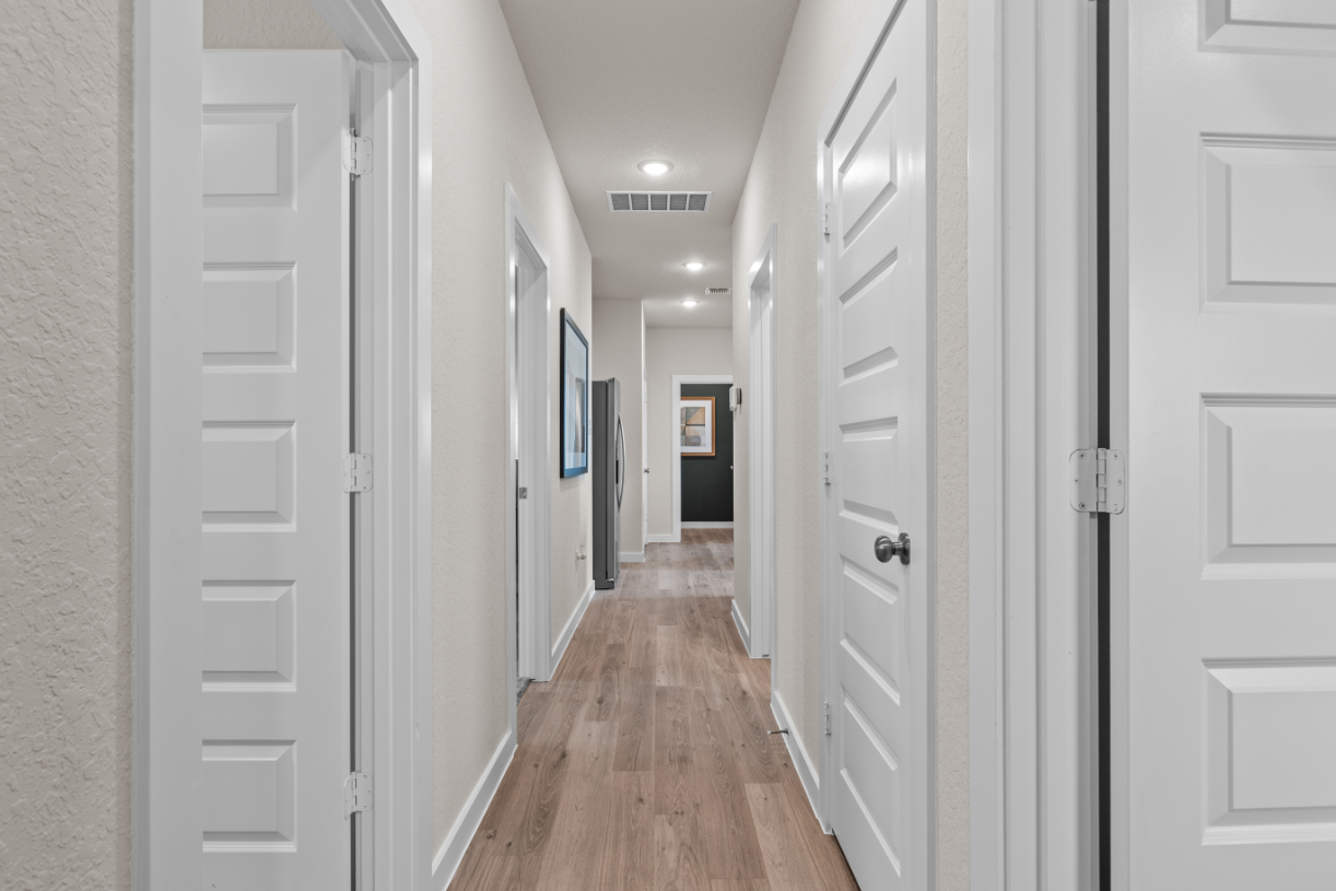 A hallway with white doors.