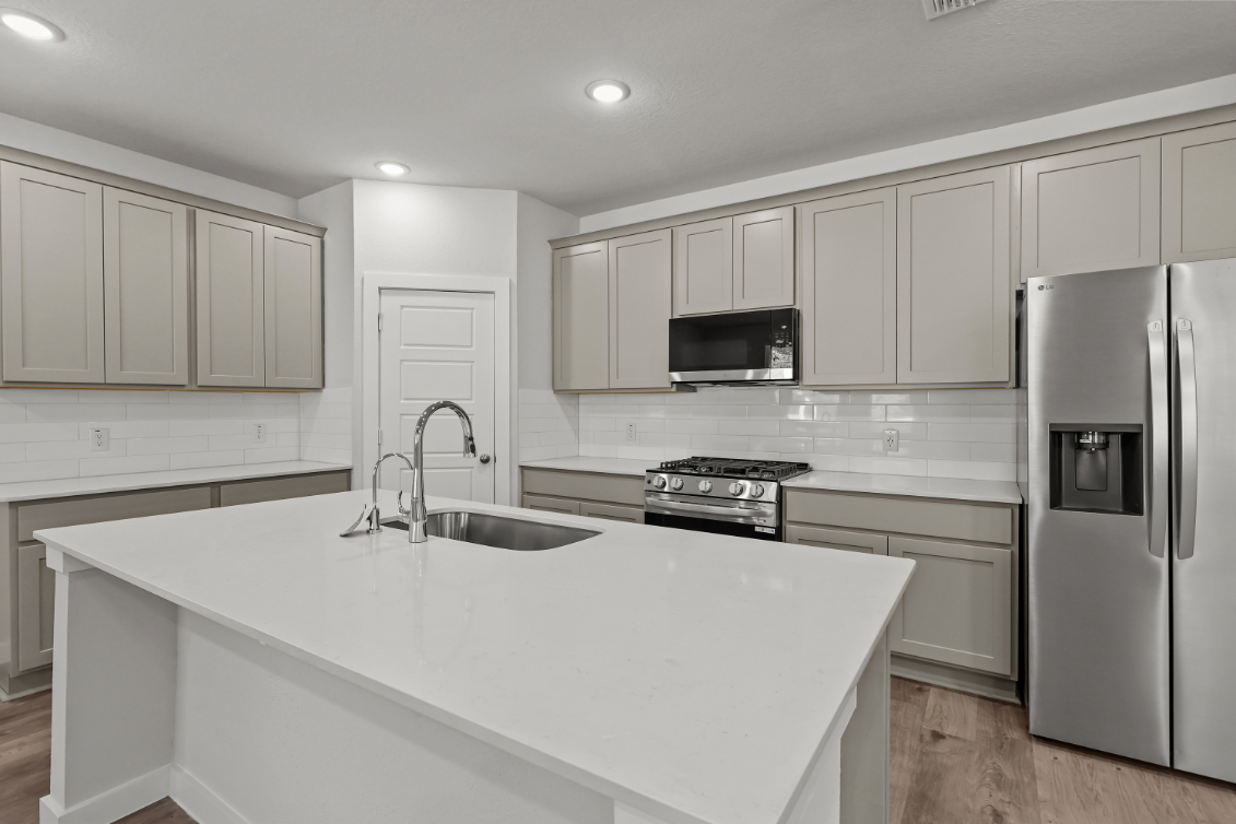 A kitchen with white cabinets.
