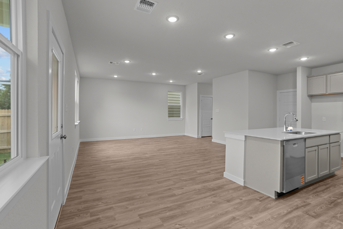 A kitchen with white cabinets.