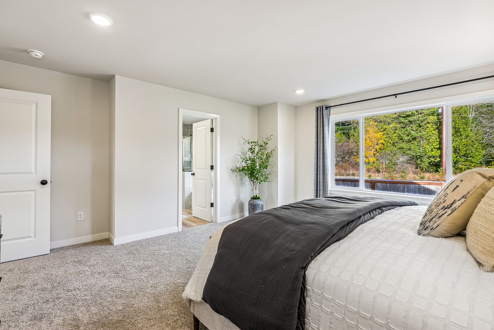 A bedroom with a bed and a window.