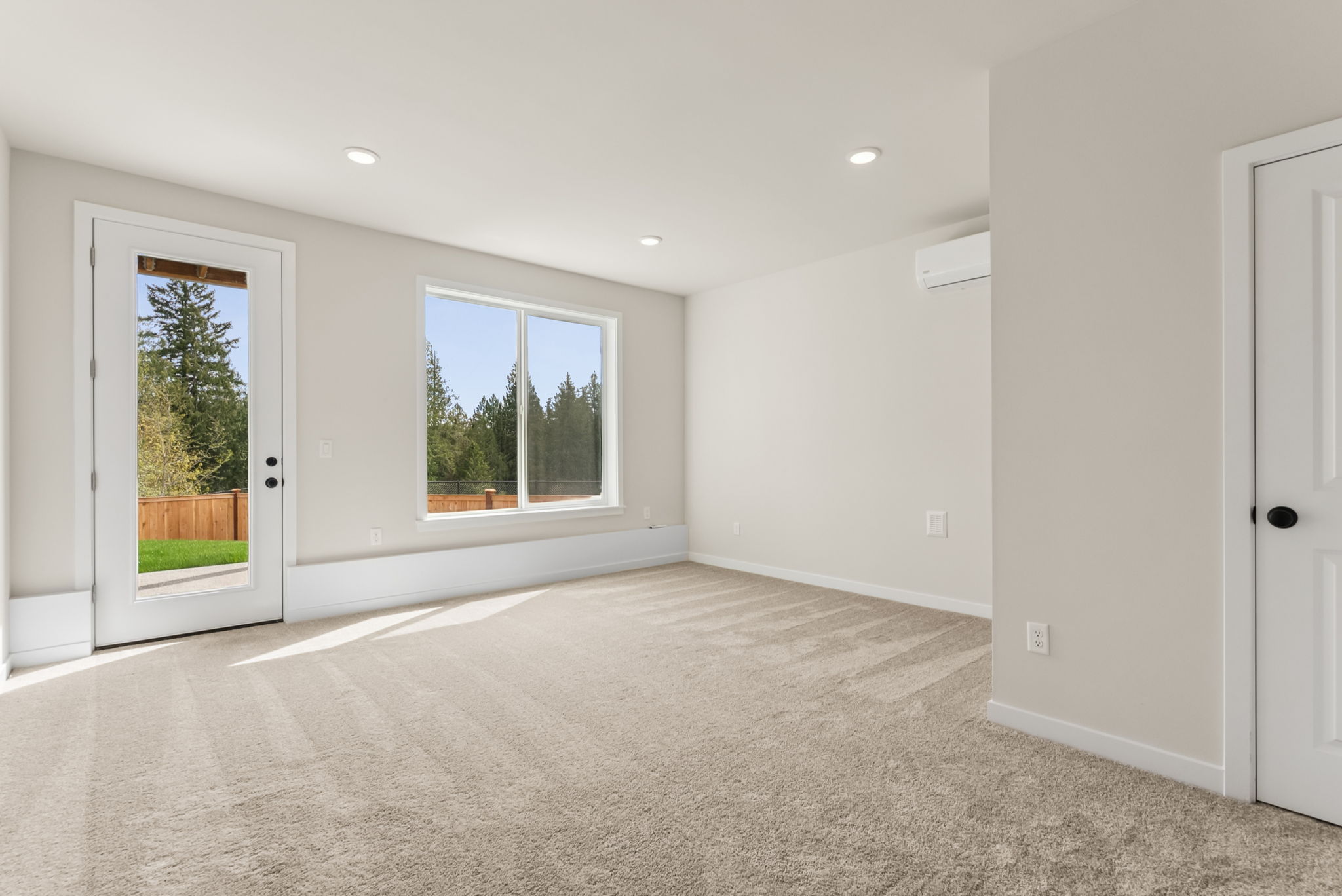 A room with white walls and windows.