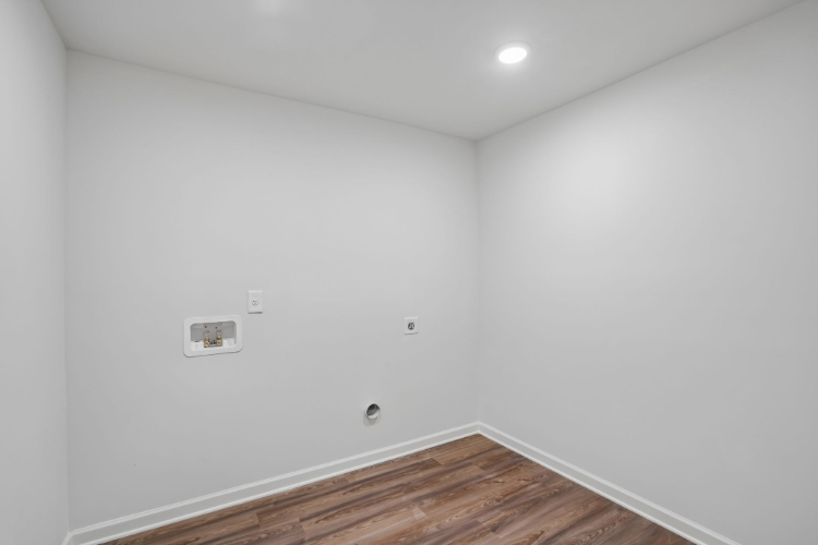 A white wall with a light on it.